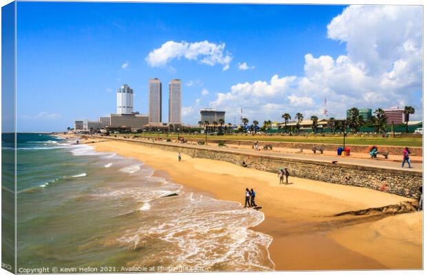 People walking on Galle Face beach Canvas Print by Kevin Hellon