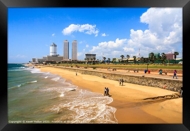People walking on Galle Face beach Framed Print by Kevin Hellon