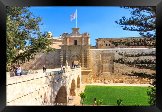 Tourists using the bridge across to the Mdina. Framed Print by Kevin Hellon