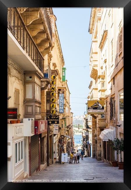 Steep street leading to the harbour. Framed Print by Kevin Hellon