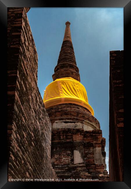 An ancient pagoda behind a brick building Framed Print by Panas Wiwatpanachat