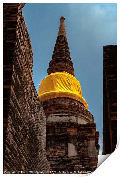 An ancient pagoda behind a brick building Print by Panas Wiwatpanachat