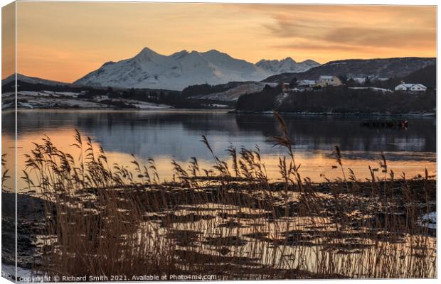 Cuillin reflections in Loch Portree, reeds in the foreground.  Canvas Print by Richard Smith