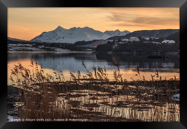 Cuillin reflections in Loch Portree, reeds in the foreground.  Framed Print by Richard Smith