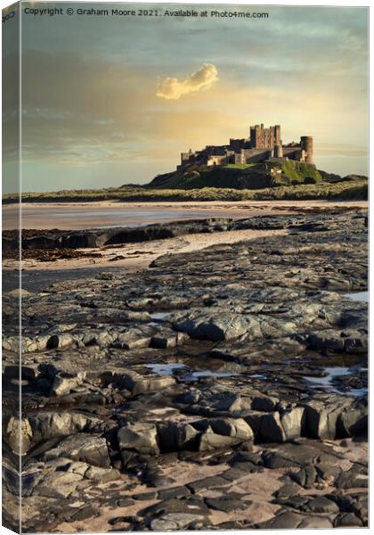 Bamburgh Castle from rocky beach Canvas Print by Graham Moore