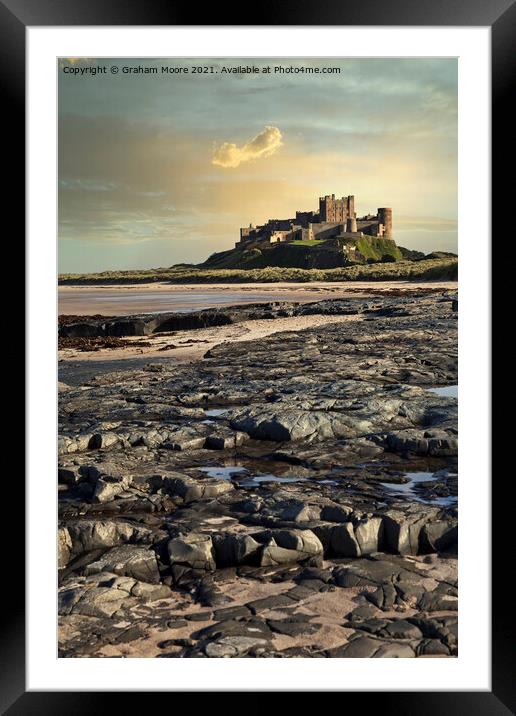 Bamburgh Castle from rocky beach Framed Mounted Print by Graham Moore