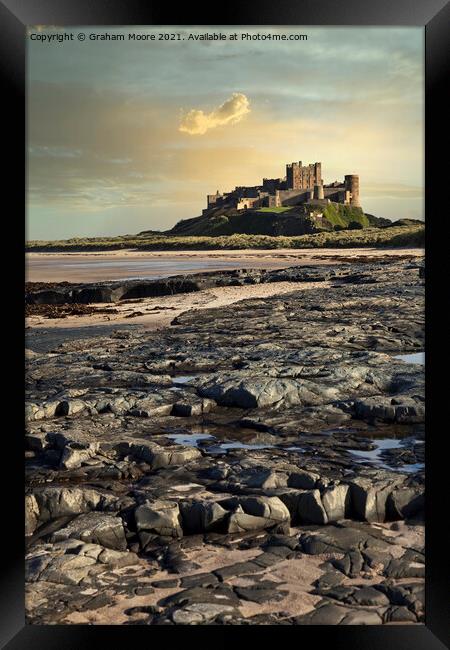 Bamburgh Castle from rocky beach Framed Print by Graham Moore