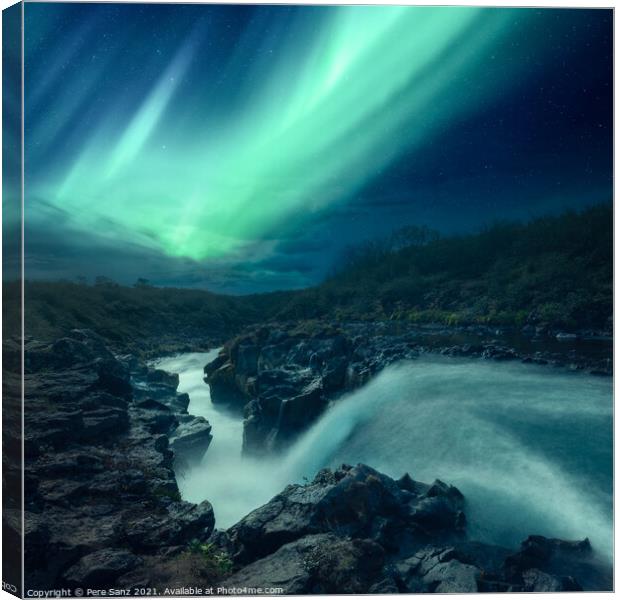 Aurora Borealis over a River in Iceland Canvas Print by Pere Sanz
