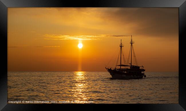 Sailing boat at sunset Framed Print by Ranko Dokmanovic
