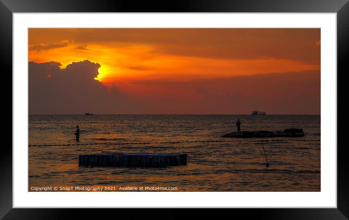 A silhouette of fishermen standing on rocks at sun Framed Mounted Print by SnapT Photography