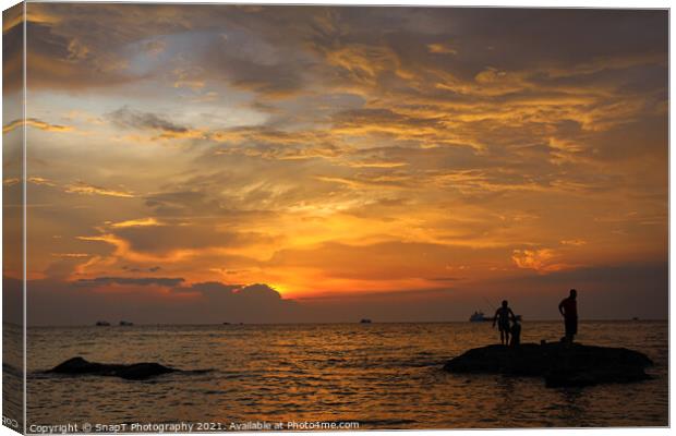 A silhouette of fishermen standing on rocks at sun Canvas Print by SnapT Photography