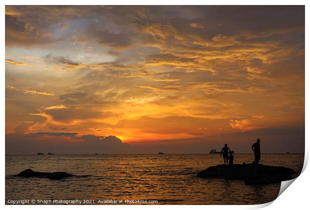 A silhouette of fishermen standing on rocks at sun Print by SnapT Photography