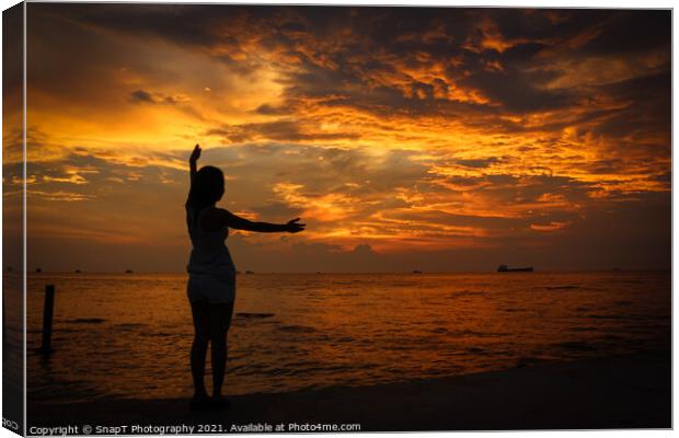 A female model silhouette controlling the movements of clouds on Ba Keo Beach Canvas Print by SnapT Photography