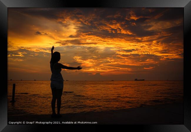 A female model silhouette controlling the movements of clouds on Ba Keo Beach Framed Print by SnapT Photography