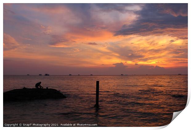 A beautiful sunset and silhouette of a person on a rock, at Ba Keo Beach Print by SnapT Photography