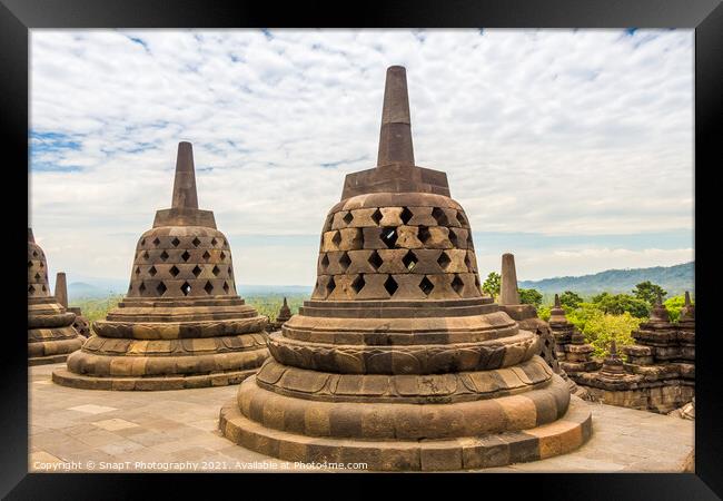 Stupas that look like bells on top of the Borobudur Buddhist temple, Indonesia Framed Print by SnapT Photography