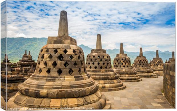 Stupas that look like bells on top of the Borobudur Buddhist temple, Indonesia Canvas Print by SnapT Photography