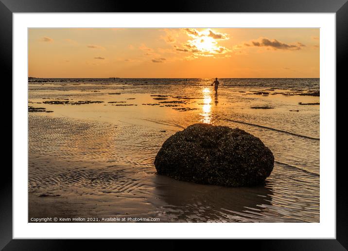 Rock and fisherman silhouette  Framed Mounted Print by Kevin Hellon