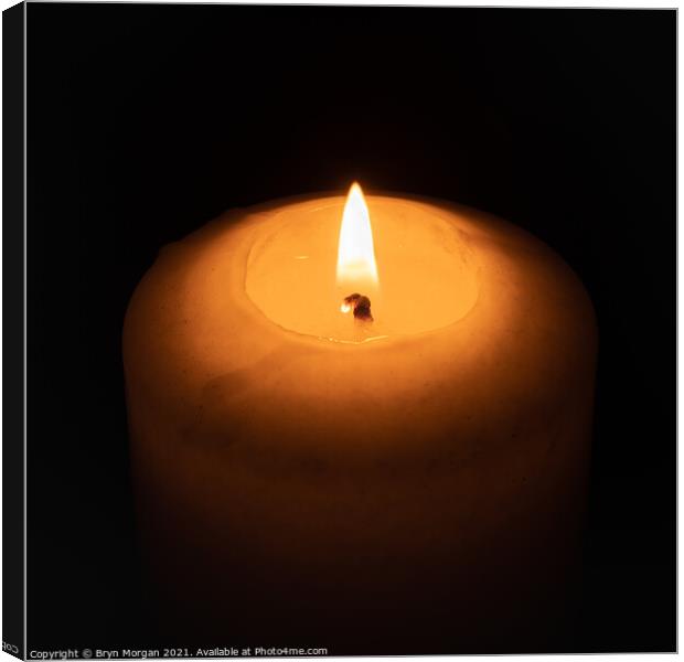 Burning candle in the darkness Canvas Print by Bryn Morgan