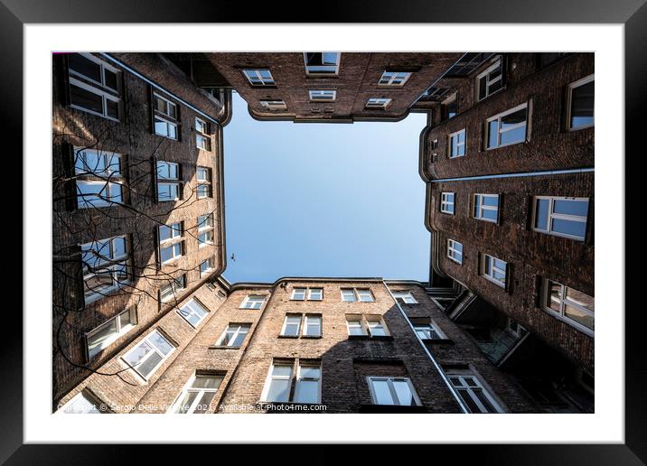 Upward view among the buildings in Warsaw Framed Mounted Print by Sergio Delle Vedove