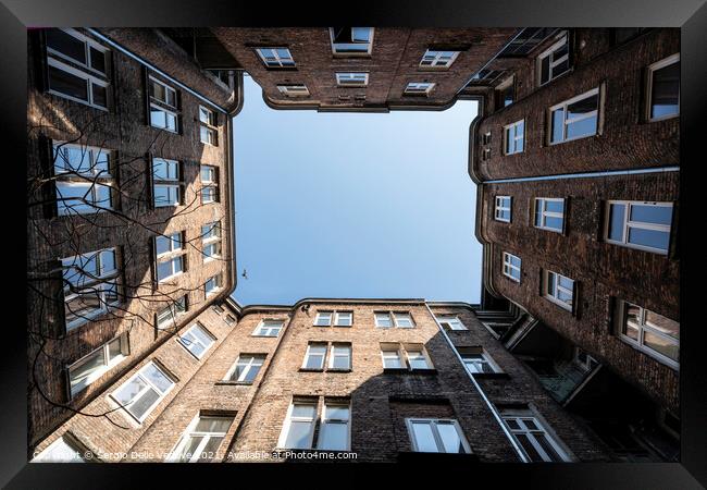 Upward view among the buildings in Warsaw Framed Print by Sergio Delle Vedove