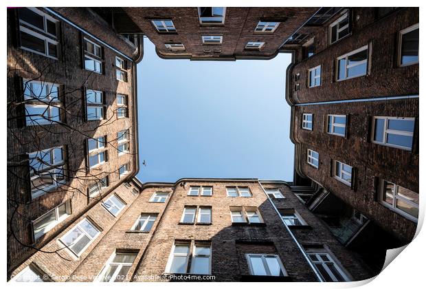 Upward view among the buildings in Warsaw Print by Sergio Delle Vedove
