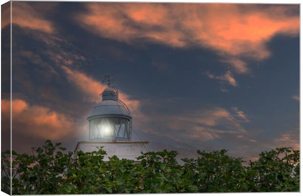 maritime lighthouse lit with sunset sky Canvas Print by David Galindo