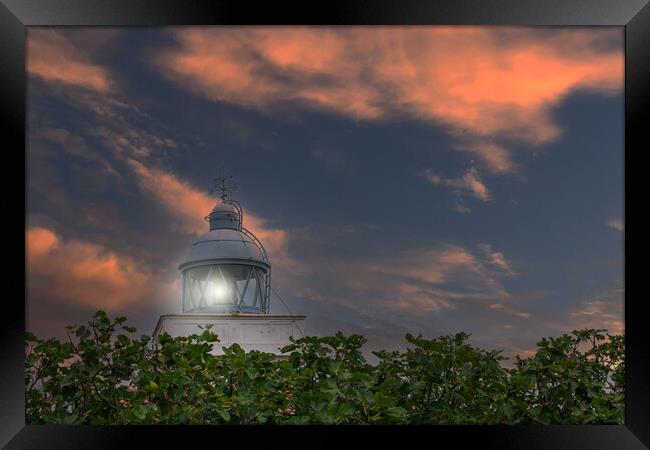 maritime lighthouse lit with sunset sky Framed Print by David Galindo