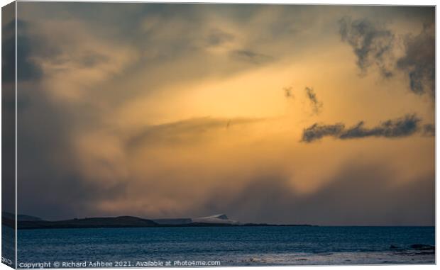 Storm clouds over a snowy Noss in Shetland Canvas Print by Richard Ashbee
