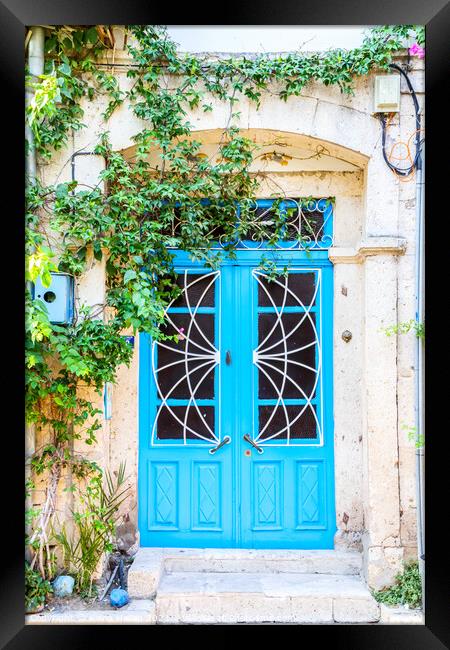 Blue door on house Framed Print by Kevin Hellon
