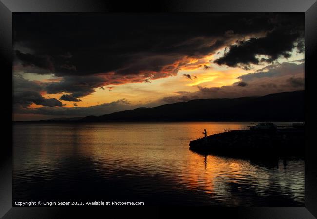 A colorful idyllic sunset after rain and dark clou Framed Print by Engin Sezer