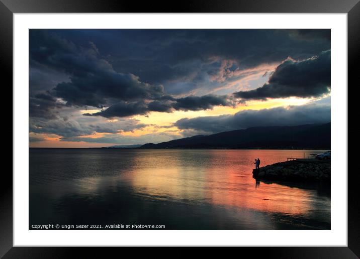 A colorful idyllic sunset after rain and reflectio Framed Mounted Print by Engin Sezer