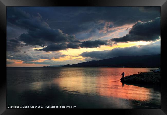 A colorful idyllic sunset after rain and reflectio Framed Print by Engin Sezer