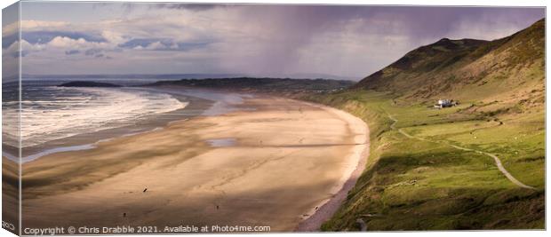 Rossili Bay with rain moving through. Canvas Print by Chris Drabble