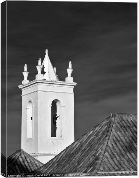 Church bell tower behind tiled roofs in Tavira Canvas Print by Angelo DeVal