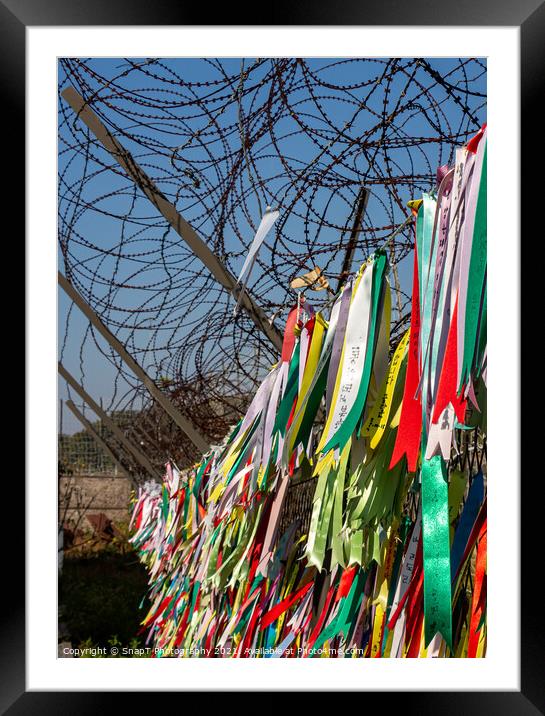 Prayer ribbons attached to a barb wire fence at the Korean Demilitarized Zone Framed Mounted Print by SnapT Photography