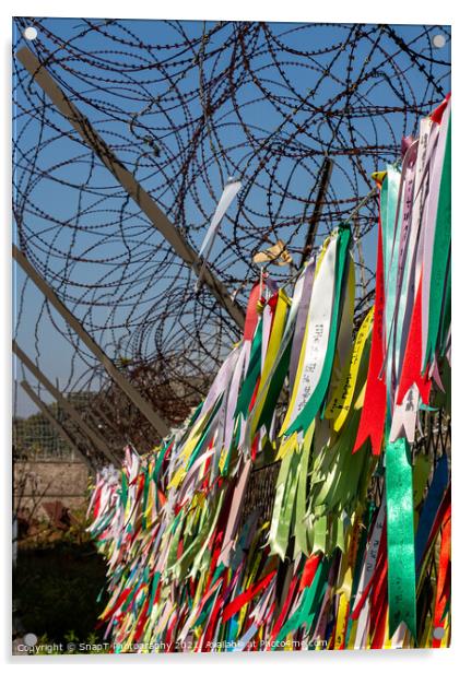 Prayer ribbons attached to a barb wire fence at the Korean Demilitarized Zone Acrylic by SnapT Photography