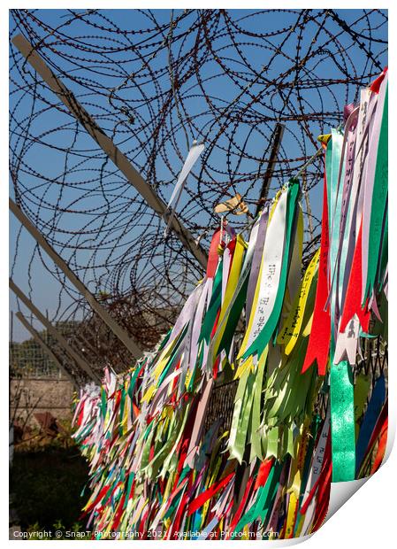 Prayer ribbons attached to a barb wire fence at the Korean Demilitarized Zone Print by SnapT Photography