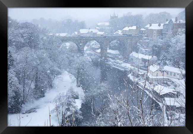 Winter snow over the river Nidd and famous landmark railway viaduct in Knaresborough, North Yorkshire. Framed Print by mike morley