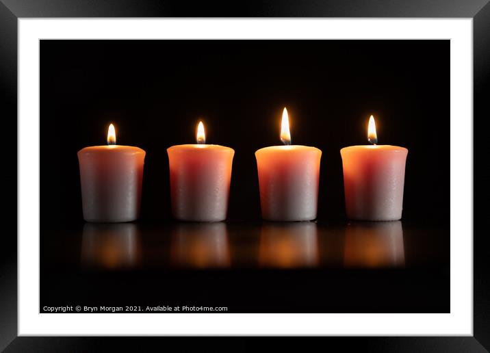 Four burning candles Framed Mounted Print by Bryn Morgan