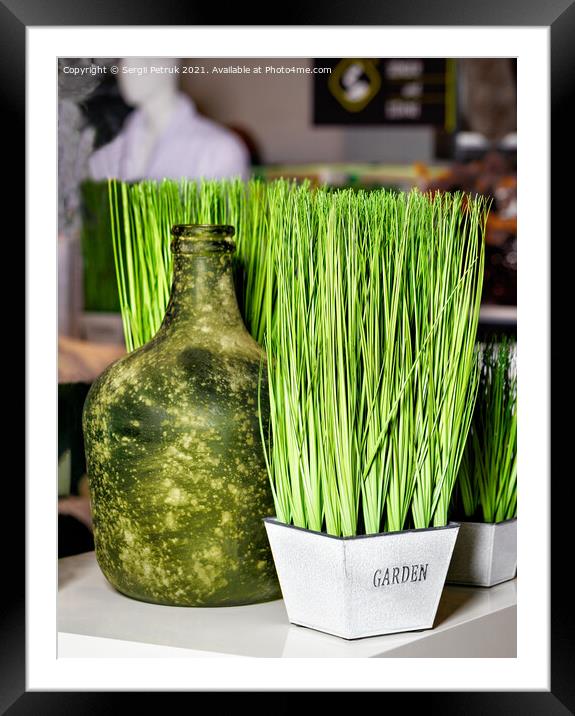 Green grass in a white pot and an old bottle as part of the restaurant's interior decoration. Framed Mounted Print by Sergii Petruk
