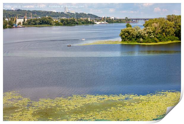 The picturesque natural landscape of the Dnipro River in the middle of summer with river lilies floating on the water in the foreground. Print by Sergii Petruk