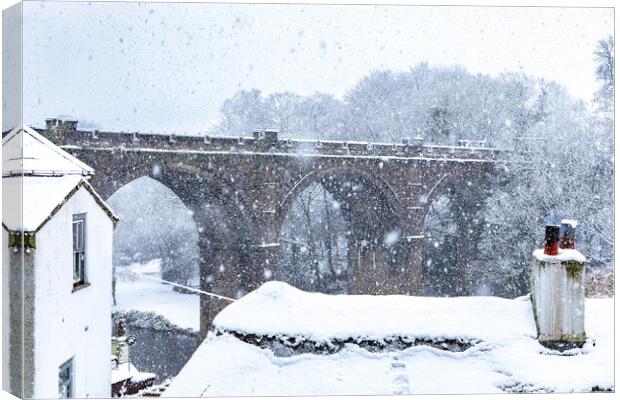 Winter snow over the river Nidd and famous landmark railway viaduct in Knaresborough, North Yorkshire.  Canvas Print by mike morley