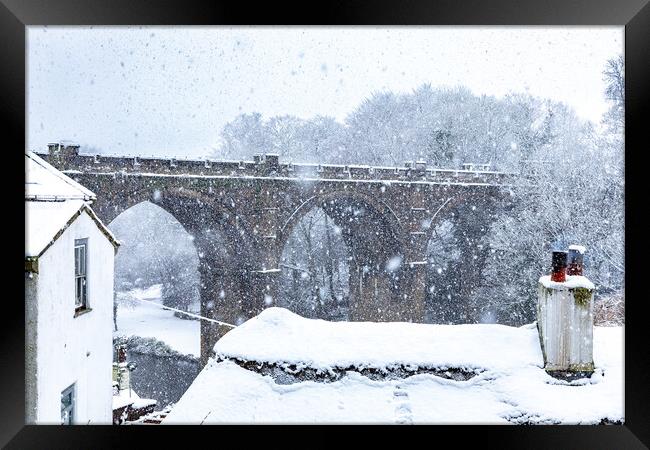 Winter snow over the river Nidd and famous landmark railway viaduct in Knaresborough, North Yorkshire.  Framed Print by mike morley