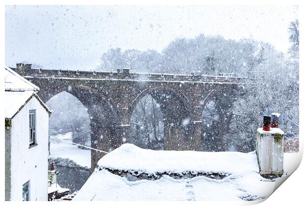 Winter snow over the river Nidd and famous landmark railway viaduct in Knaresborough, North Yorkshire.  Print by mike morley