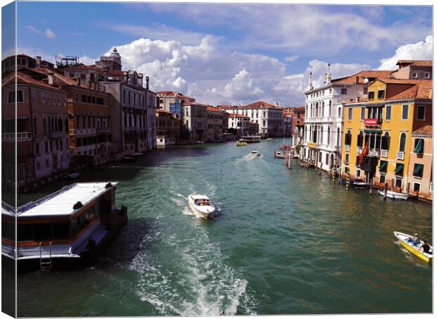 Venice, Italy: View of a canal with boats between italian architecture against dramatic clouds Canvas Print by Arpan Bhatia