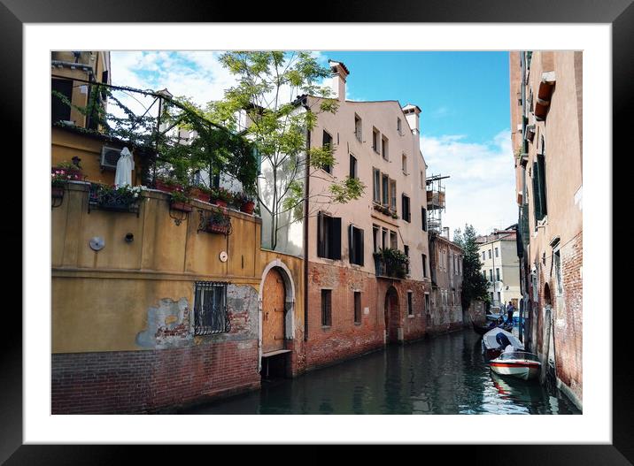 Venice, Italy : Wide angle shot of rusty italian architecture on river canal with gandola boats against clear blue sky Framed Mounted Print by Arpan Bhatia