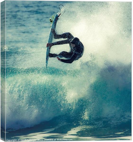 A surfer takes to the 'air' Canvas Print by Geoff Tydeman
