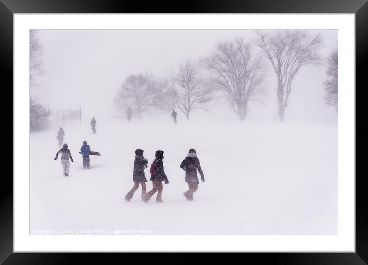 People outside ina blizzard in Quebec Framed Mounted Print by Colin Woods
