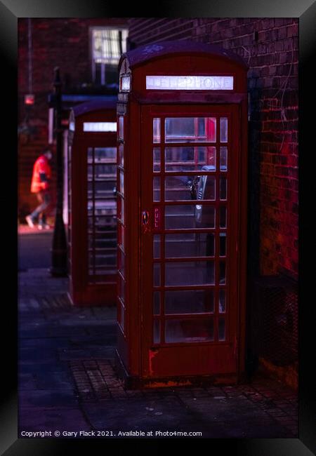 Red English Telephone boxes in a night time street Framed Print by That Foto